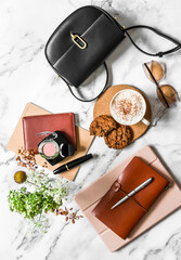 Women's office desk - notebooks, organizer, tablet, cappuccino cup and cookies with chocolate drops...
