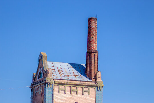 Old Austrian meat factory building with a high chimney