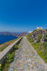 Fototapeta na wymiar Pathway along the caldera volcano on the island of Santorini, Greece with a beautiful sea view. No people. 