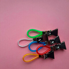 multi-colored clips on a pink background