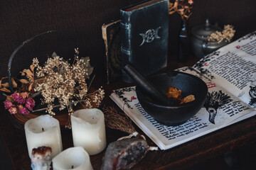 Wiccan witch altar prepared for casting a spell with an open Book of Shadows and pestle and mortar...