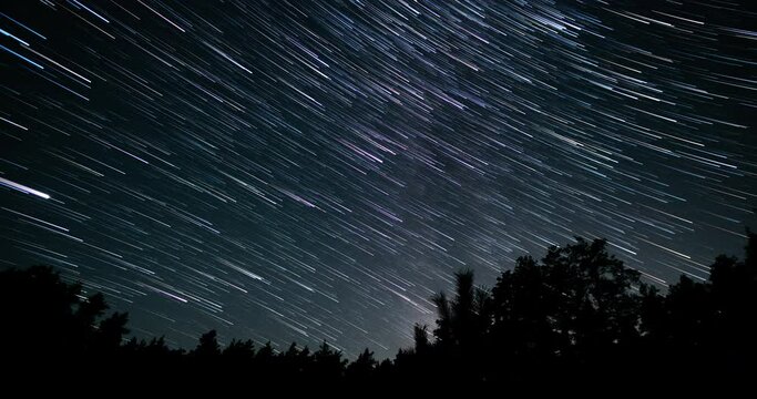 Comet-shaped star trails in the night sky