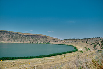 Magnificent blue sky and turquoise color lake of Narli Gol Crater and geothermal field covered by many hills. © SKahraman