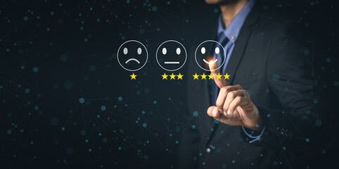 Customer Service and Satisfaction Concept Businessmen touch the virtual screen on happy smiley icons to achieve service satisfaction and feedback with excellent rated reviews.