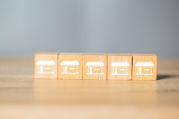 Cubes wood Franchise business,Businessman hand choose wooden blog with franchise marketing store...