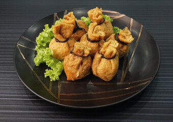 steamed bean curd skin wrapped with meat ball fortune bag dumpling on dark grey wood background dim sum menu