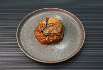 handmade steamed lomaigai sticky glutinous rice with chicken and mushroom on dark grey wood...