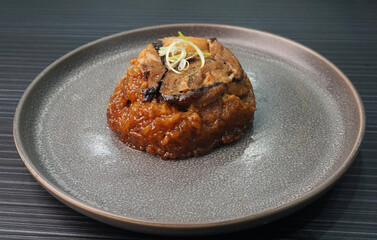 handmade steamed lomaigai sticky glutinous rice with chicken and mushroom on dark grey wood background Hong Kong dim sum menu