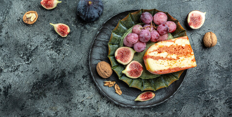 Obraz na płótnie Canvas Marble delicous cheese served figs, grapes and walnuts, banner, menu, recipe place for text, top view