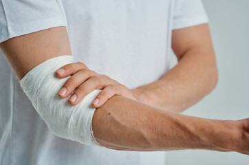 sick man bandaged hand injury to fingers isolated background