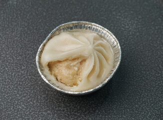 handmade steamed Shanghai Xiao long bao pork meat dumpling soup on dark grey wood background dim sum menu