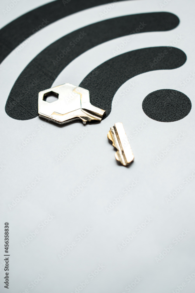 Poster vertical shot of a broken key on a white background with the wifi signal