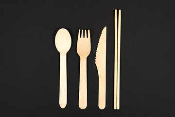 Eco cutlery made of wood and bamboo. Sushi forks, spoons and chopsticks with place for text on a...