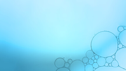 Oil droplets on water surface to created pattern and shapes background with baby blue colour.