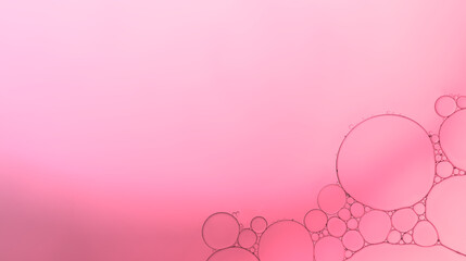 Oil droplets on water surface to createrd bubbles, circle shape and pattern with soft pink gradient background.
