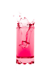 Pink softdrink  splashing out of glass creating an art shape  isolated on white background.	