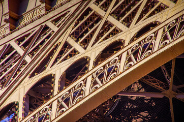 Slanted view of the Eiffel Tower in Paris, detailed view of the iron structures