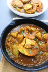 Indian non-vegetarian food  Homemade Egg Curry or Anda masala gravy, baida curry. Indian spicy food. Perfect Indian lunch. over moody background with copy space.