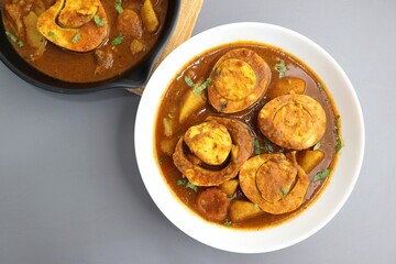 Indian non-vegetarian food  Homemade Egg Curry or Anda masala gravy, baida curry. Indian spicy food. Perfect Indian lunch. over moody background with copy space.