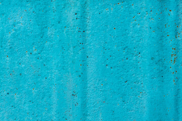 Cracked painted old metal texture. Abstract background of painted turquoise surface. Grunge blue wall background