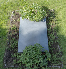 Aerial top down drone photo of single blank empty grave stone no writing on tombstone in Antwerp...