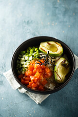 Healthy rice bowl with salmon and grilled avocado