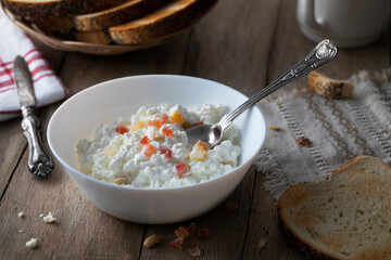 Homemade cottage cheese with candied fruits on a wooden table