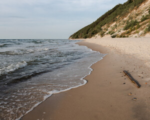 Beautiful seascape. Wild rocky sandy seashell beach. A small cozy bay.