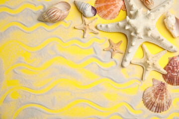 Beautiful sea stars, shells and sand on yellow background, flat lay