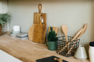 Scandinavian style kitchen utensils. Wooden cutting boards, wooden spoons and shovels. Christmas decor