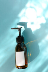 Natural skincare cosmetics, creams and oils on blue background. Plant-based beauty products.