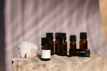 different cosmetics products on rock, Essential oils or face toner samples