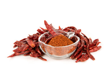 Dried red chilli and powder isolated on white surface.