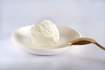 A ball of word ice cream lies in the man on a light table, next to it lies a golden spoon.