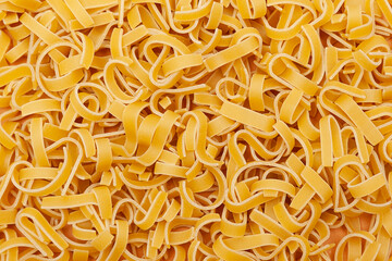 Background of raw fettuccine pasta