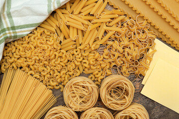 Various types of raw pasta, flat lay