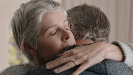 sad mature woman hugging husband sharing bad news to emotional wife couple embracing stressful retirement marriage problems 4k footage