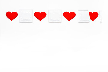 
White blank condom packed and red heart shape. Empty space for text, mock-up.  Safe sex concept.