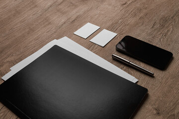 Branding Mockup. Corporate stationary on wooden background, dark and bright objects. Side view.