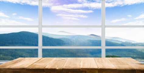 Fototapeta na wymiar table background free space for your product and blurred landscape of mountains. Blue sky with sunlight.