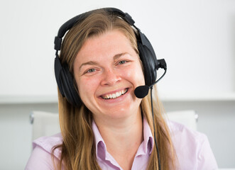 Smiling woman worker working effectively at call-center