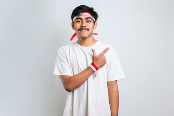 man wearing red and white headband pointing with hand finger to the side