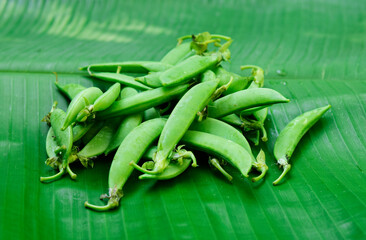 Fresh green peas on banana leaves
