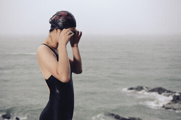 Young woman is looking at the beach by the pool