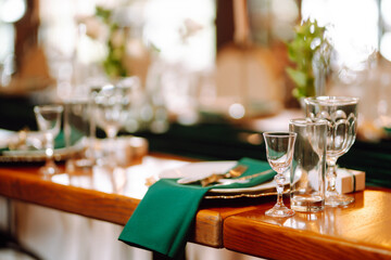Beautiful decorated table for the event in the restaurant in emerald color. Wedding, birthday, party, event concept.