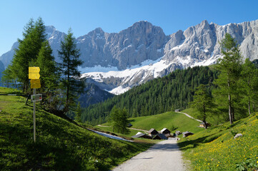 a beautiful alpine village Neustatt Alm or Neustatt valley by the foot of snowy Dachstein mountain...