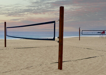 beach volleyball net on empty beach at dusk