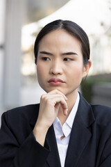 Stressed and unhappy asian woman office worker thinking