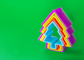 Christmas tree symbol on a green background. Christmas cookie cutters.