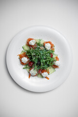 top view of fresh salad with salmon, cream cheese or arugula on white background